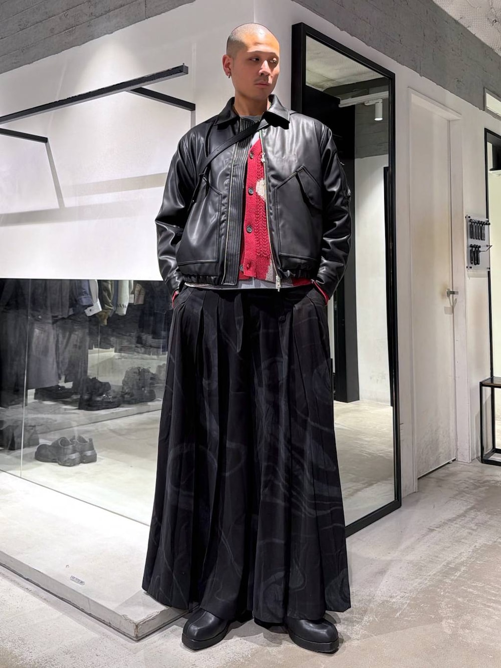 ブラック系のブルゾン、グレー系のその他パンツ、レッド系のカーディガン/ボレロを着用したメンズの冬コーディネートの1枚目の写真