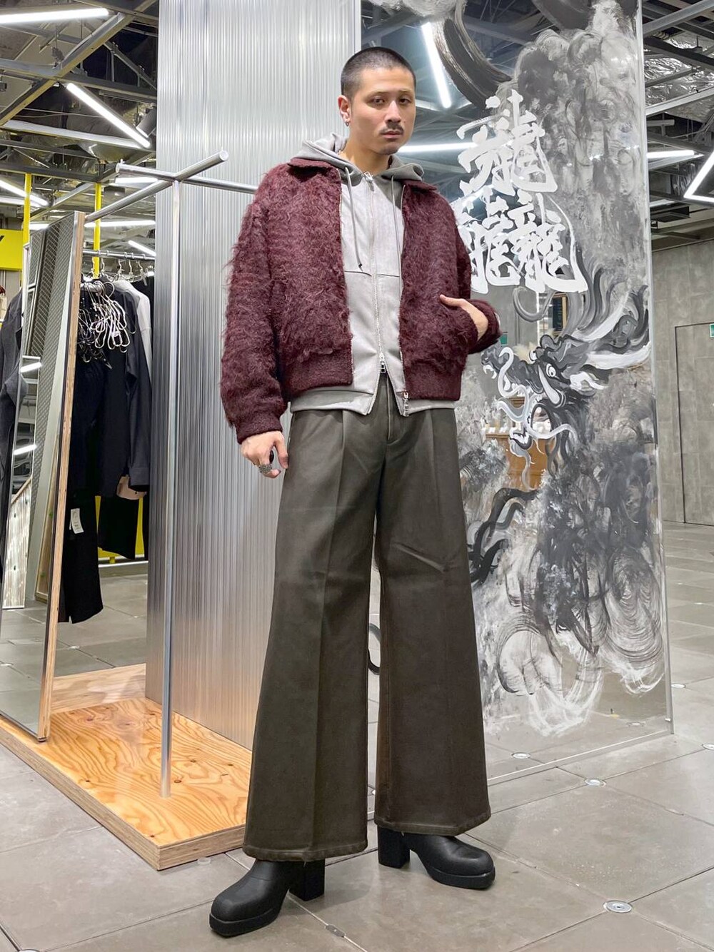 ブラウン系のその他パンツ、ブラック系のブーツ、グレー系のパーカーを着用したメンズの冬コーディネートの1枚目の写真