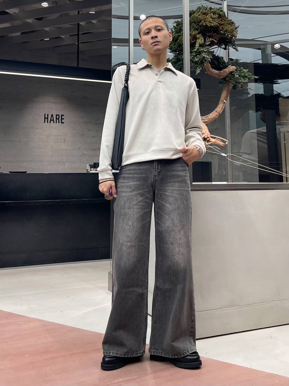 ブラック系のローファー、ブラウン系のデニムパンツ、ブラック系のトートバッグを着用したメンズの秋コーディネートの1枚目の写真