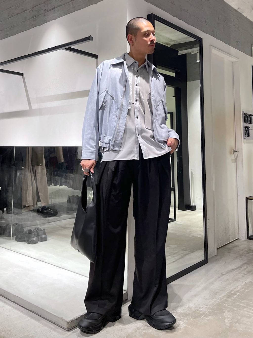 ブラック系のトートバッグ、ブルー系のブルゾン、グレー系のシャツ/ブラウスを着用したメンズの冬コーディネートの1枚目の写真