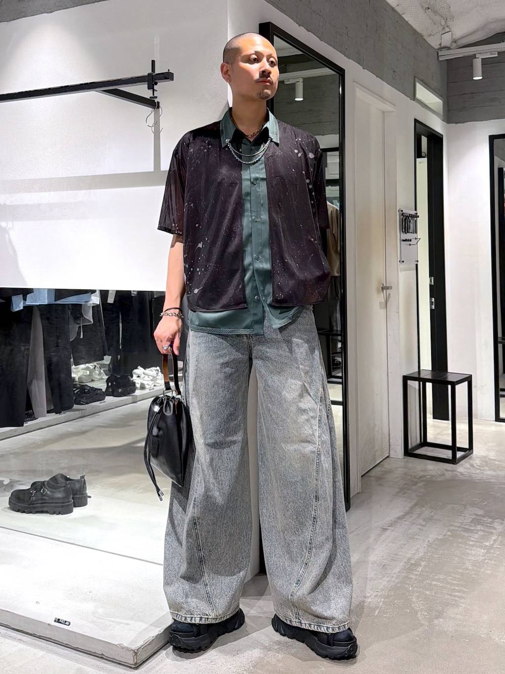 ブルー系のデニムパンツ、ブラック系のサンダル、ブラック系のショルダーバッグを着用したメンズの夏コーディネートの1枚目の写真