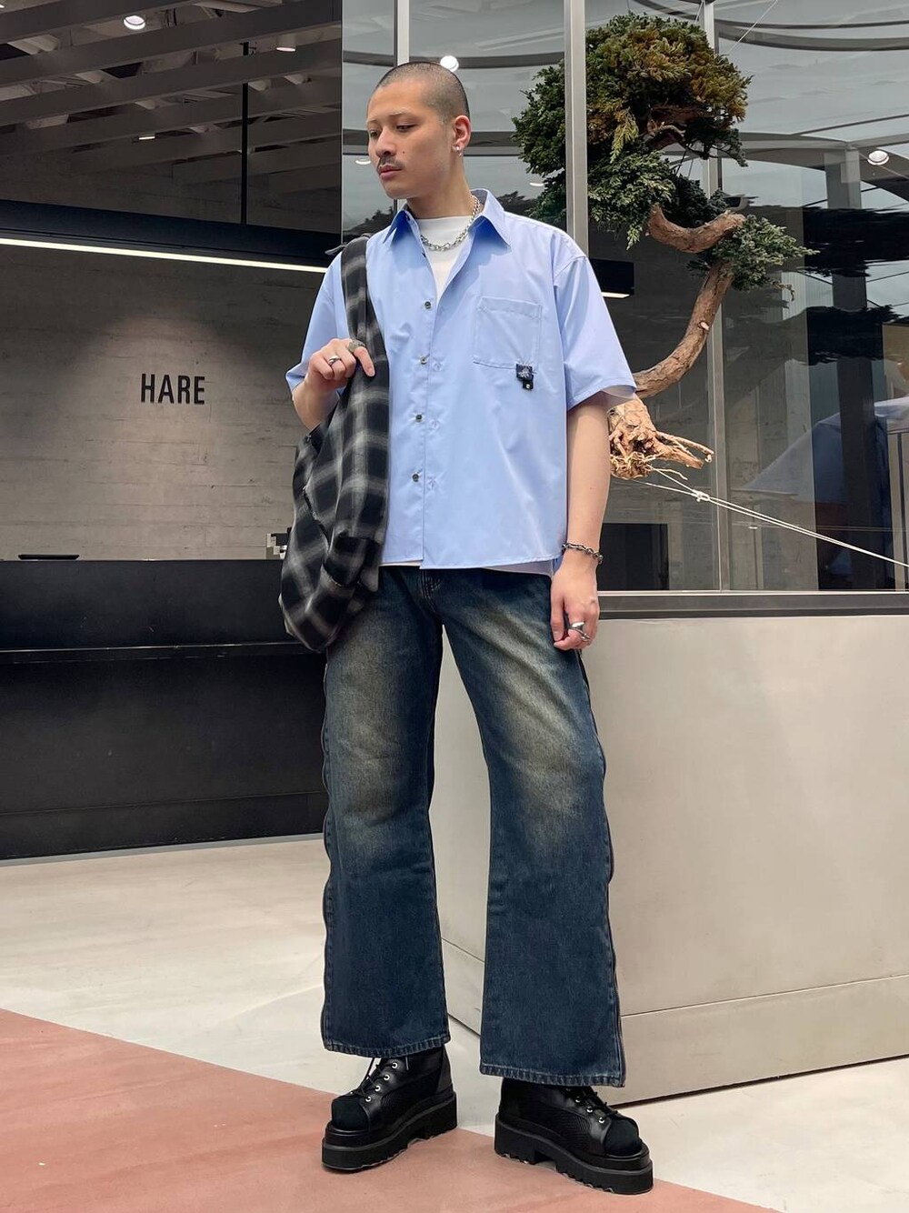ブルー系のデニムパンツ、ブラック系のショルダーバッグ、ブラック系のサンダルを着用したメンズの春コーディネートの1枚目の写真