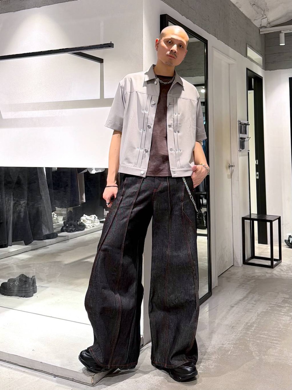 ブラック系のスニーカー、ブラック系のデニムパンツ、グレー系のシャツ/ブラウスを着用したメンズの春コーディネートの1枚目の写真