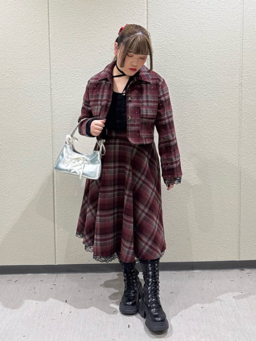 ブラック系のブーツ、レッド系のテーラードジャケット、レッド系のスカートを着用したレディースの冬コーディネートの1枚目の写真