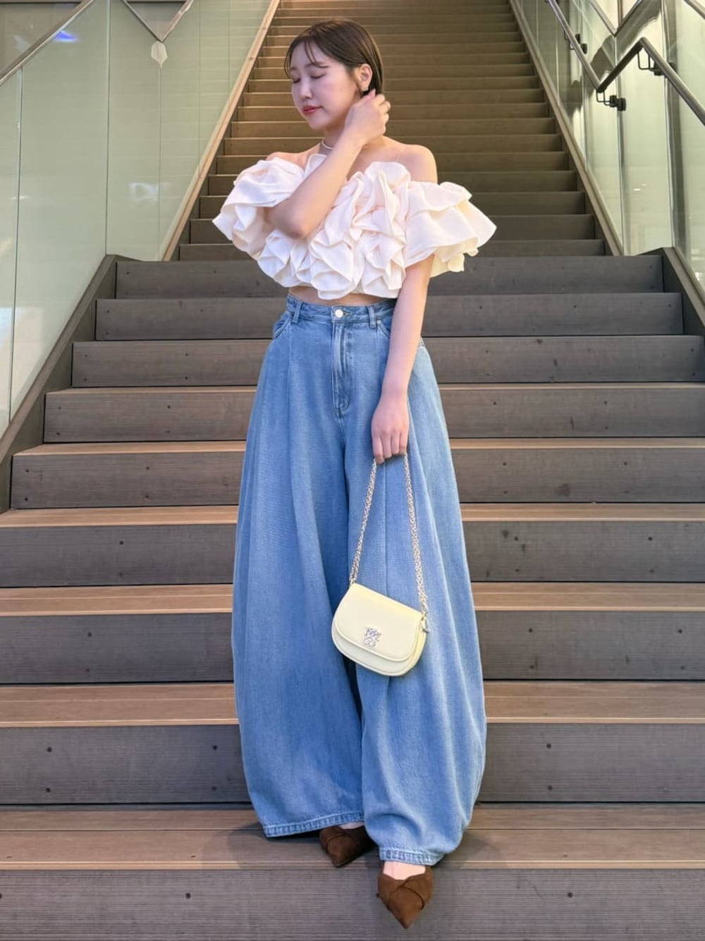 ホワイト系のシャツ/ブラウス、ブラウン系のパンプス、イエロー系のショルダーバッグを着用したレディースの冬コーディネートの1枚目の写真