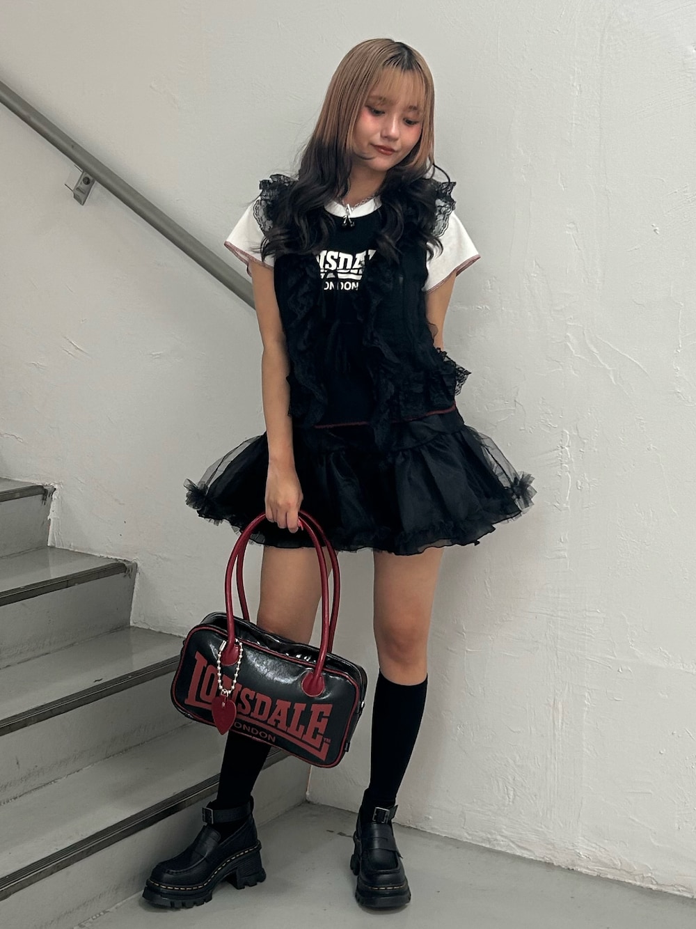 ブラック系のTシャツ/カットソー、ブラック系のスカート、ブラック系のボストンバッグを着用したレディースの夏コーディネートの1枚目の写真