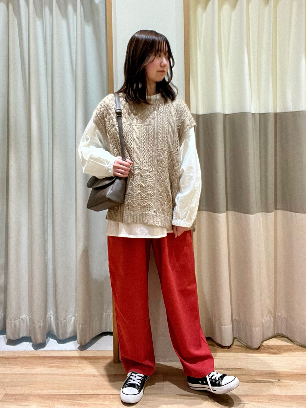 レッド系のその他パンツ、ベージュ系のベスト、ホワイト系のシャツ/ブラウスを着用したレディースの冬コーディネートの1枚目の写真