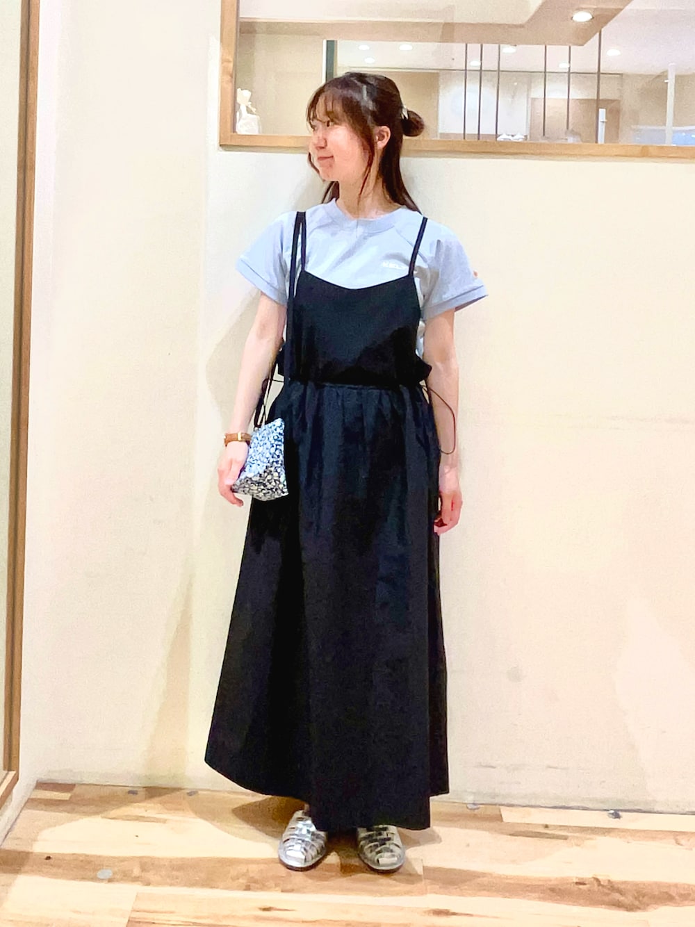ブルー系のハンドバッグ、ブラック系のワンピース、ブルー系のTシャツ/カットソーを着用したレディースの春コーディネートの1枚目の写真