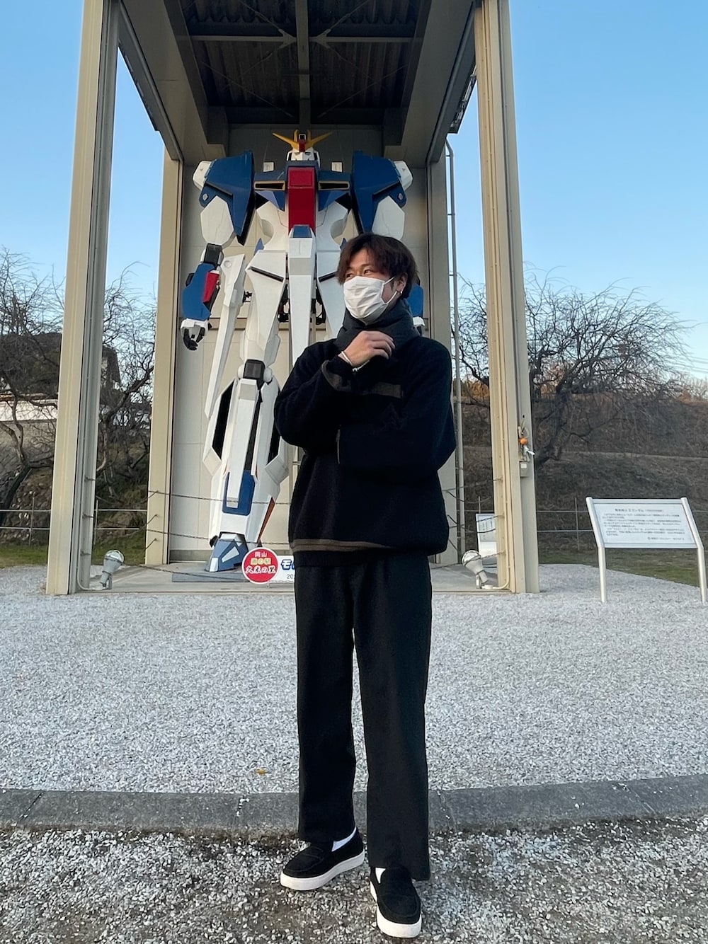 ブラック系のニット/セーター、ブラック系のスラックス、ブラック系のローファーを着用したメンズの冬コーディネートの1枚目の写真