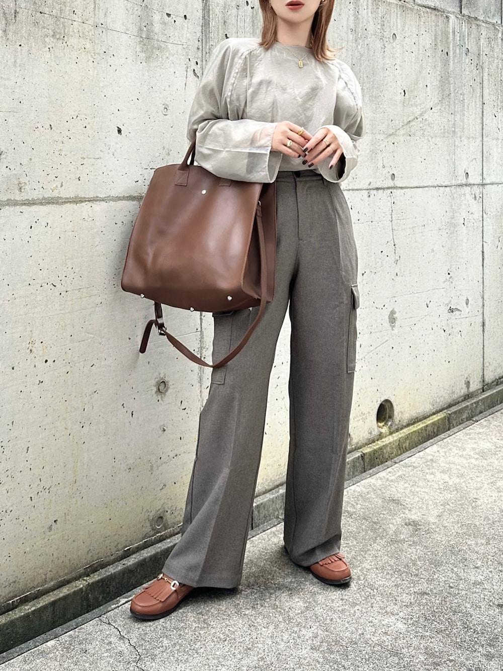 ベージュ系のシャツ/ブラウス、ブラウン系のカーゴパンツ、ブラウン系のバッグを着用したレディースの秋コーディネートの1枚目の写真
