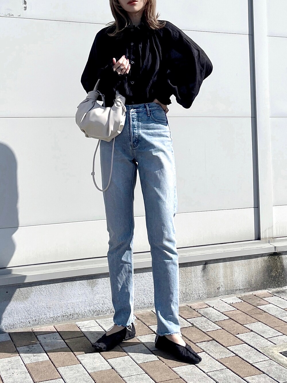 ブラック系のシャツ/ブラウス、ブルー系のデニムパンツ、ホワイト系のバッグを着用したレディースの冬コーディネートの1枚目の写真