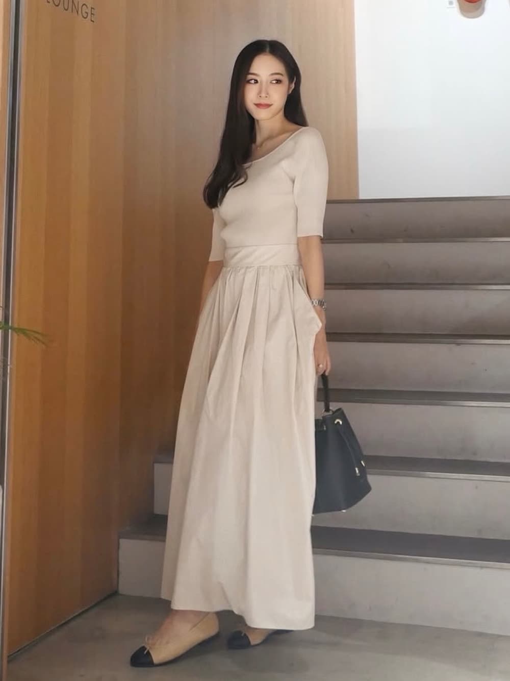 ホワイト系のワンピース/ドレス、ブラック系のバッグを着用したレディースの秋コーディネートの1枚目の写真