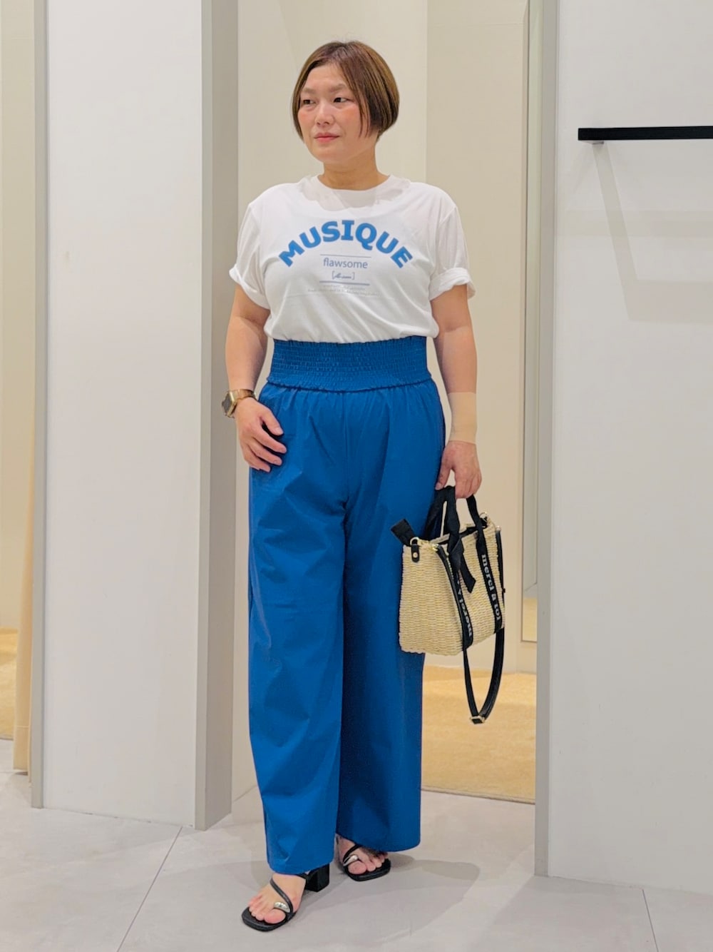 ホワイト系のTシャツ/カットソー、ブルー系のその他パンツ、ベージュ系のハンドバッグを着用したレディースの夏コーディネートの1枚目の写真