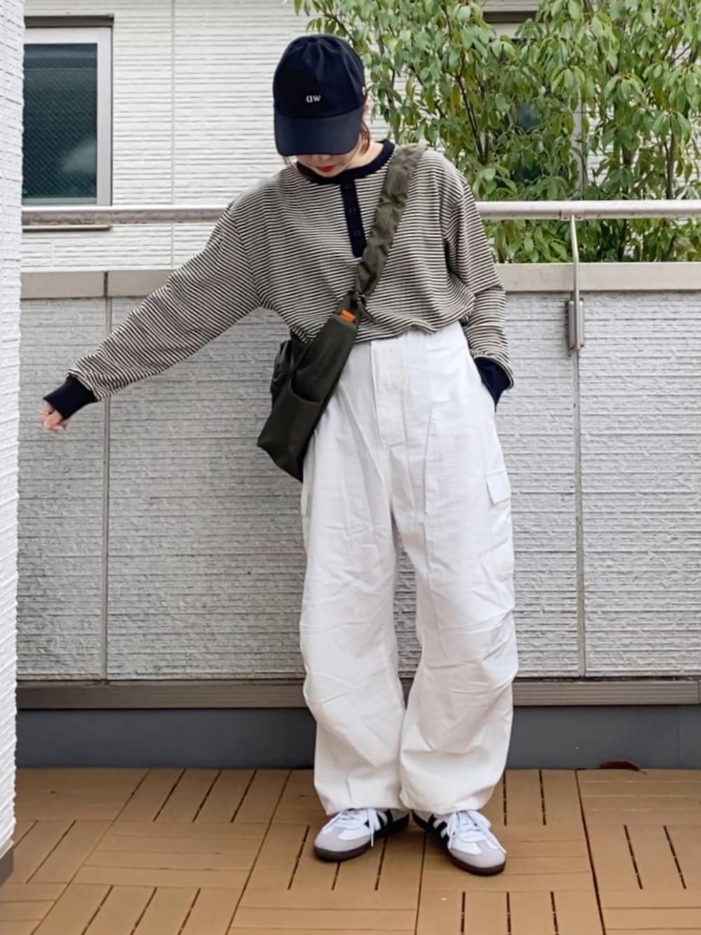 ホワイト系のTシャツ/カットソー、ホワイト系のカーゴパンツ、グリーン系のショルダーバッグを着用したレディースの春コーディネートの1枚目の写真