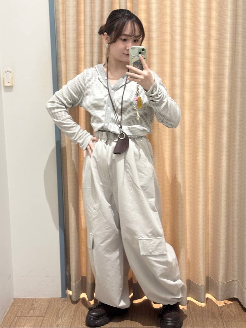 ブラウン系のスニーカー、グレー系のその他パンツ、グレー系のカーディガン/ボレロを着用したレディースの秋コーディネートの1枚目の写真