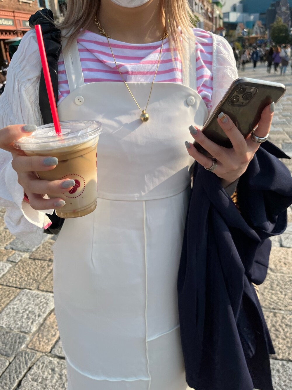 ピンク系のTシャツ/カットソー、ホワイト系のワンピース/ドレス、ブラック系のブーツを着用したレディースの春コーディネートの4枚目の写真