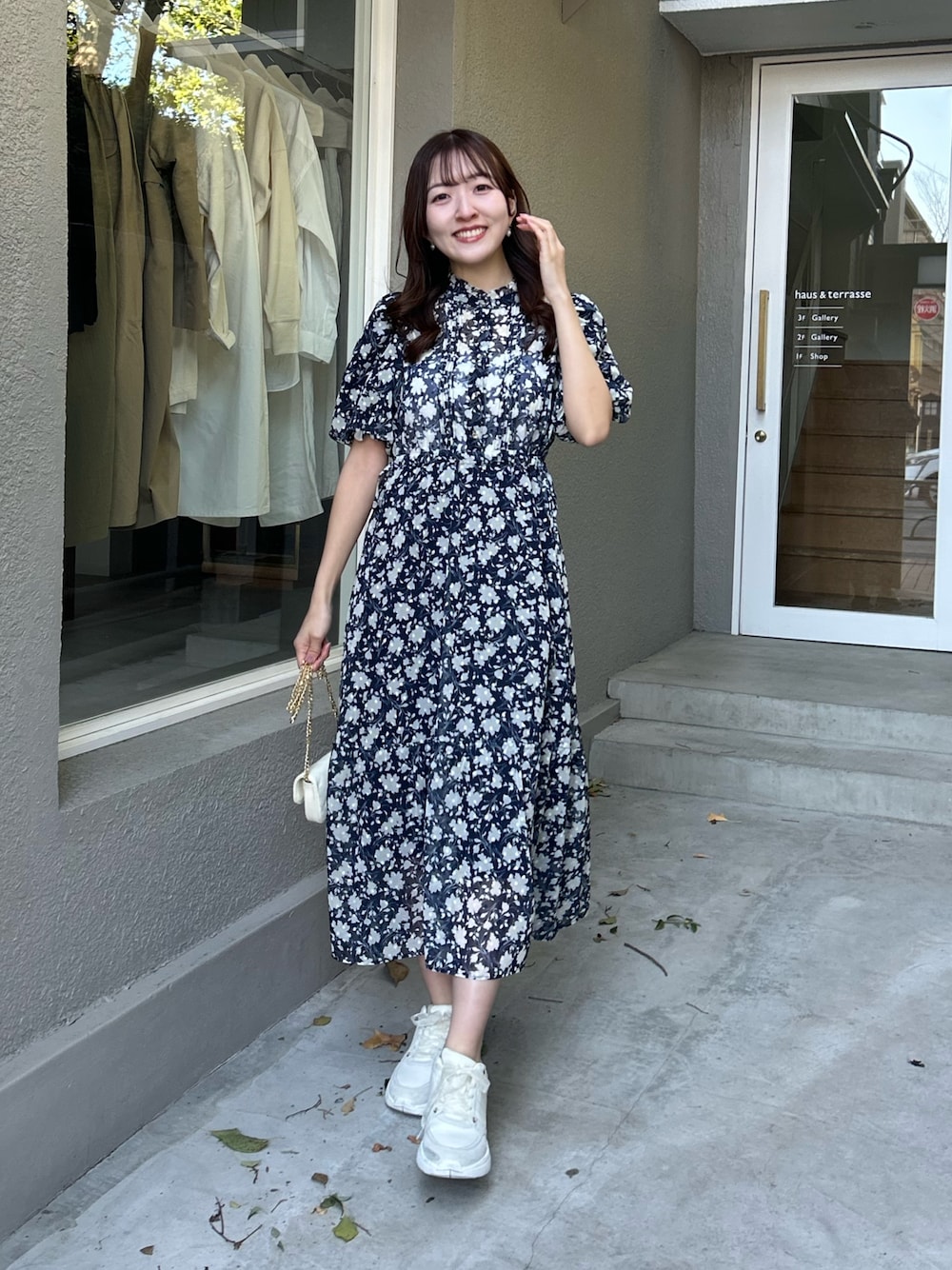 ブルー系のワンピースを着用したレディースの春コーディネートの1枚目の写真
