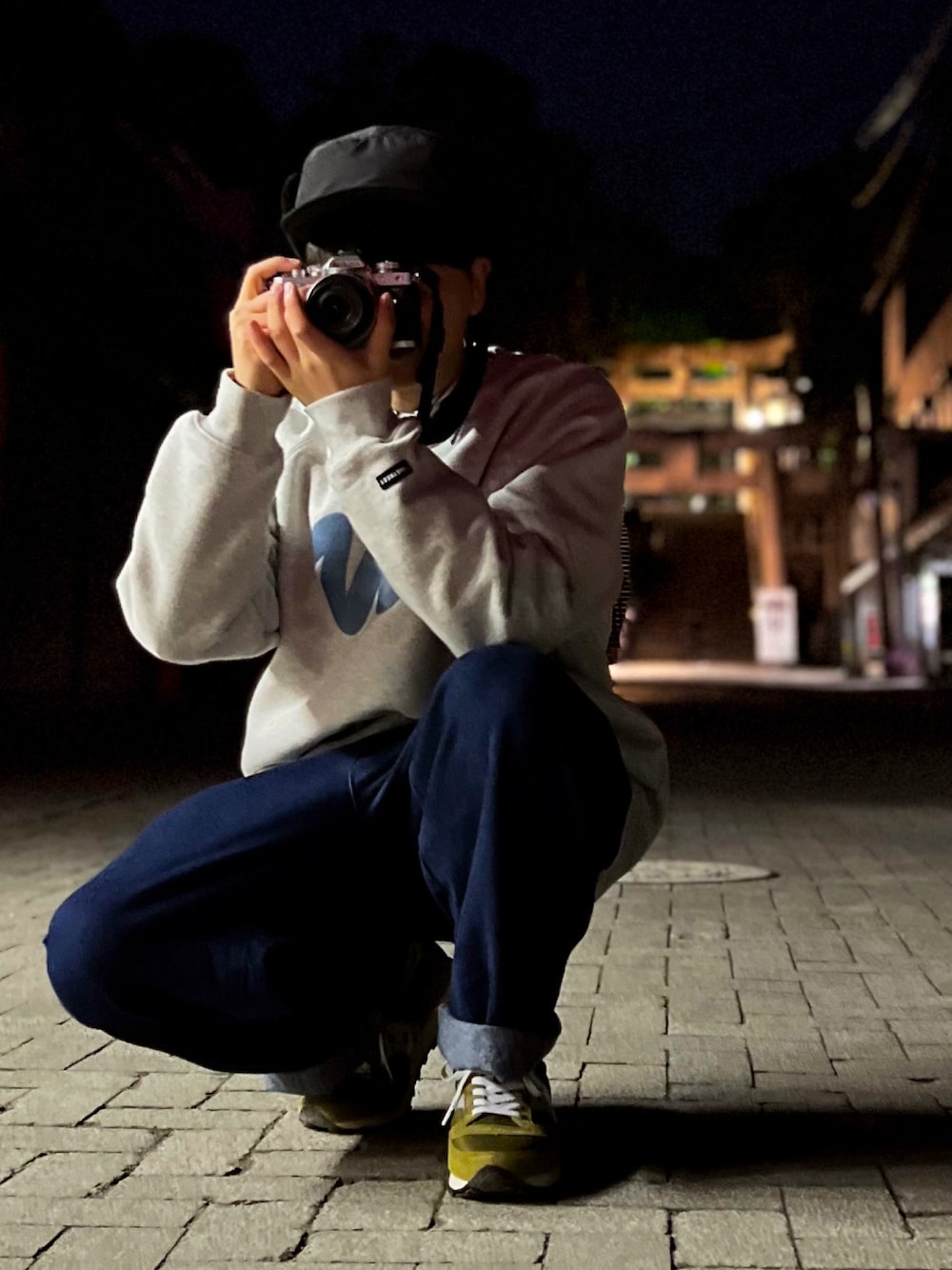 ブルー系のデニムパンツ、グリーン系のスニーカー、グレー系のスウェットを着用したメンズの冬コーディネートの1枚目の写真