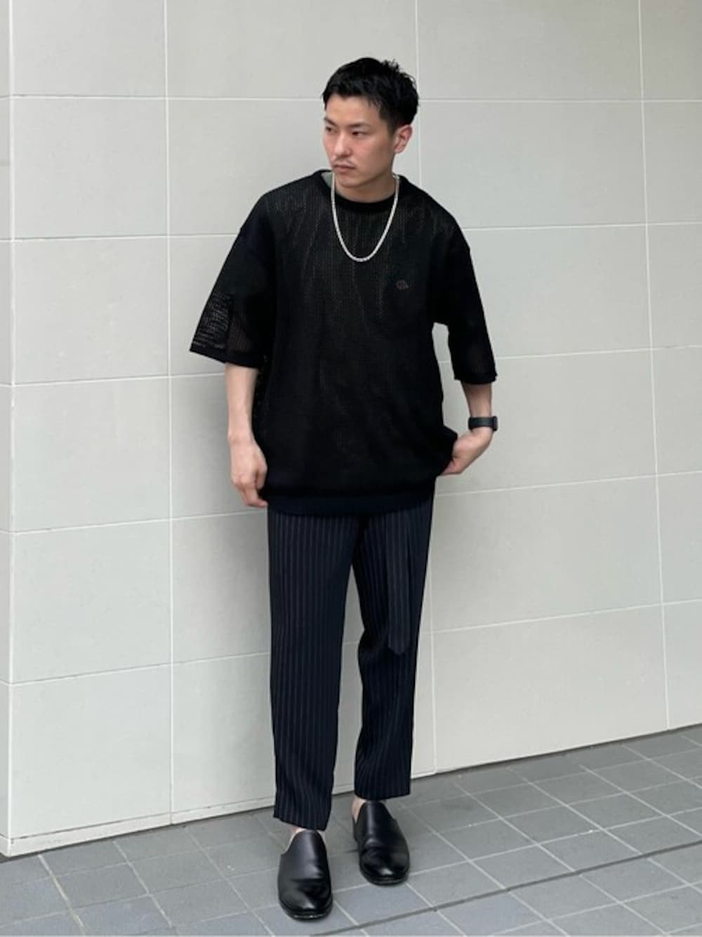 ブラック系のニット/セーター、ブラック系のスラックスを着用したメンズの秋コーディネートの1枚目の写真