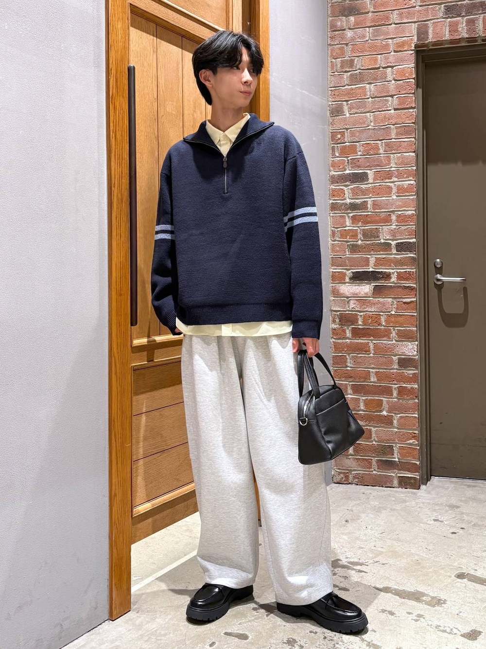 ブラック系のドレスシューズ、グレー系のスウェットパンツ、イエロー系のシャツ/ブラウスを着用したメンズの冬コーディネートの1枚目の写真
