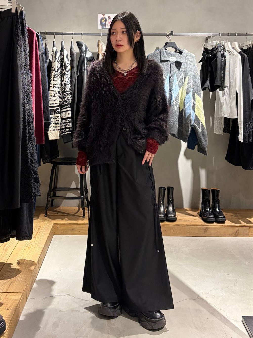 ブラック系のカーディガン/ボレロ、ブラック系のその他パンツ、レッド系のTシャツ/カットソーを着用したレディースの秋コーディネートの1枚目の写真