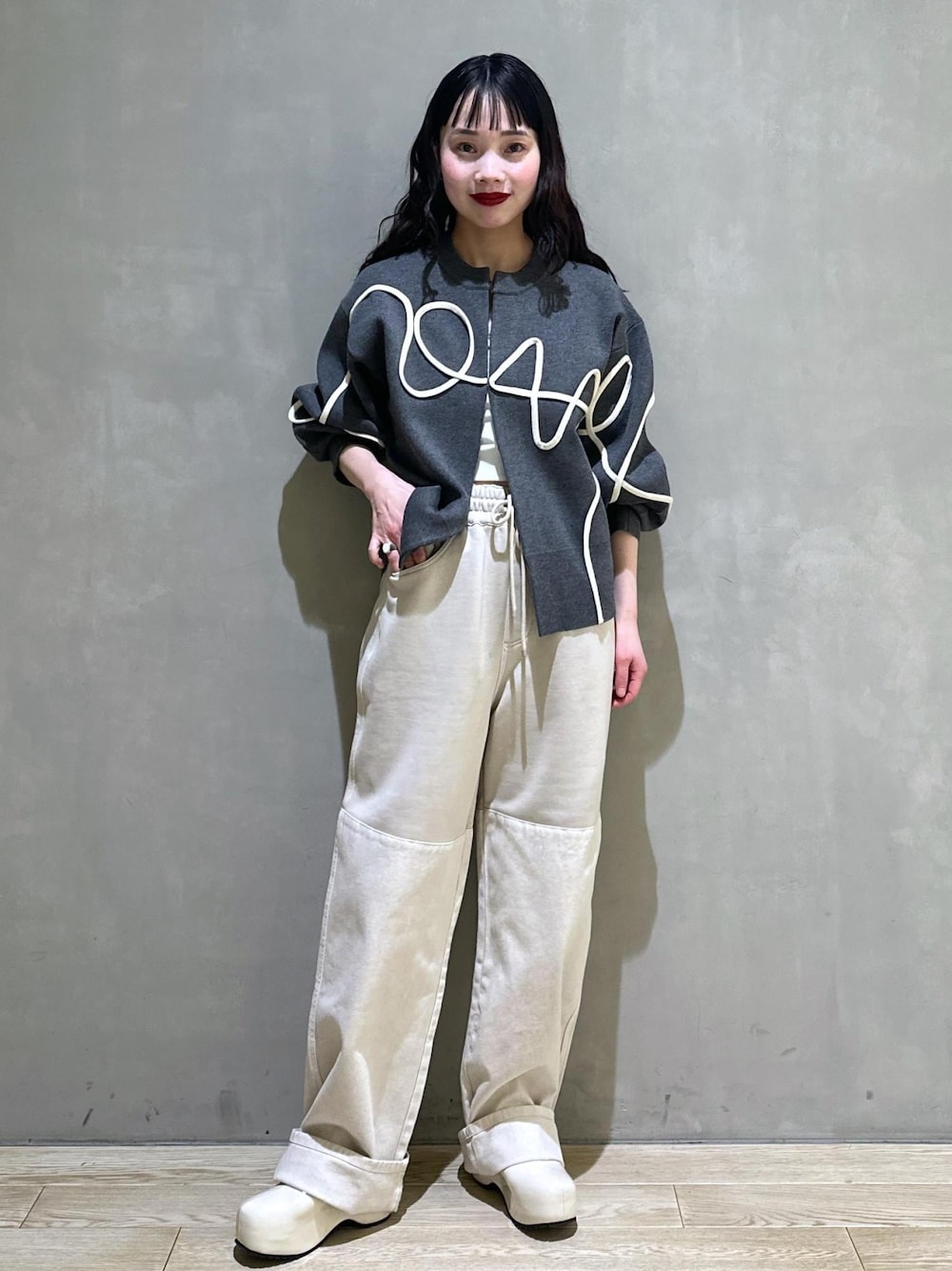 ホワイト系のサンダル、グレー系のカーディガン/ボレロを着用したレディースの冬コーディネートの1枚目の写真