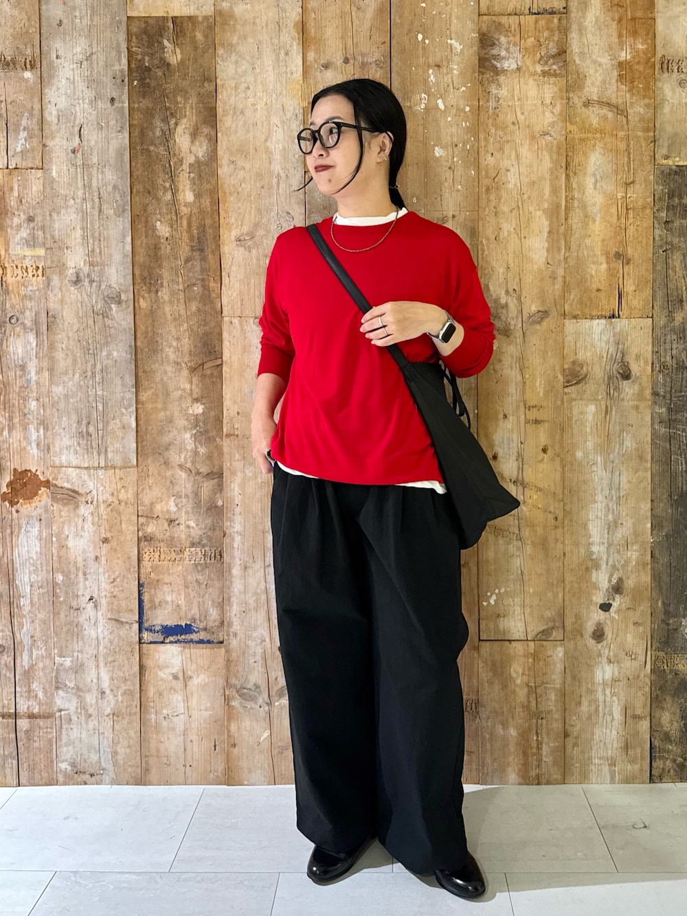 レッド系のニット/セーター、ホワイト系のTシャツ/カットソー、ブラック系のその他パンツを着用したレディースの秋コーディネートの1枚目の写真