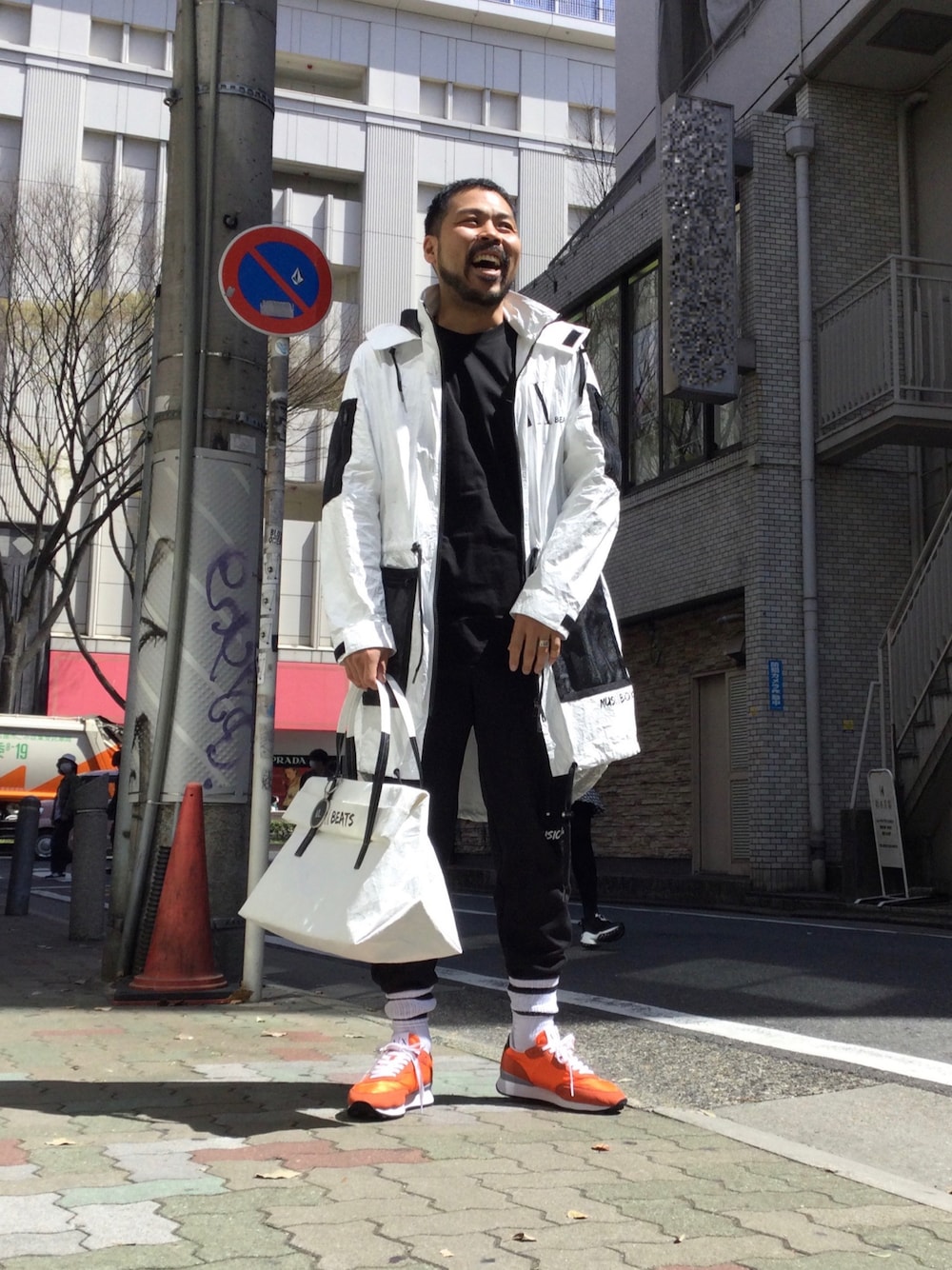「アルマーニエクスチェンジ、アルマーニ、ビッグシルエット、カジュアルコーデ、armaniexchange、ARMANIEXCHANGE、armani、AXchanger、白アウター、オレンジ、カラースニーカー、休日スタイル、コート、モノトーンコーデ、モノトーンに差し色」｜「ARMANI EXCHANGEの【A|X アルマーニ エクスチェンジ】AX BEATS　ビッグペーパートートバッグ（トートバッグ、ホワイト系）」を使った、Ponzさん（メンズ・179cm）の春コーディネートの1枚目の写真
