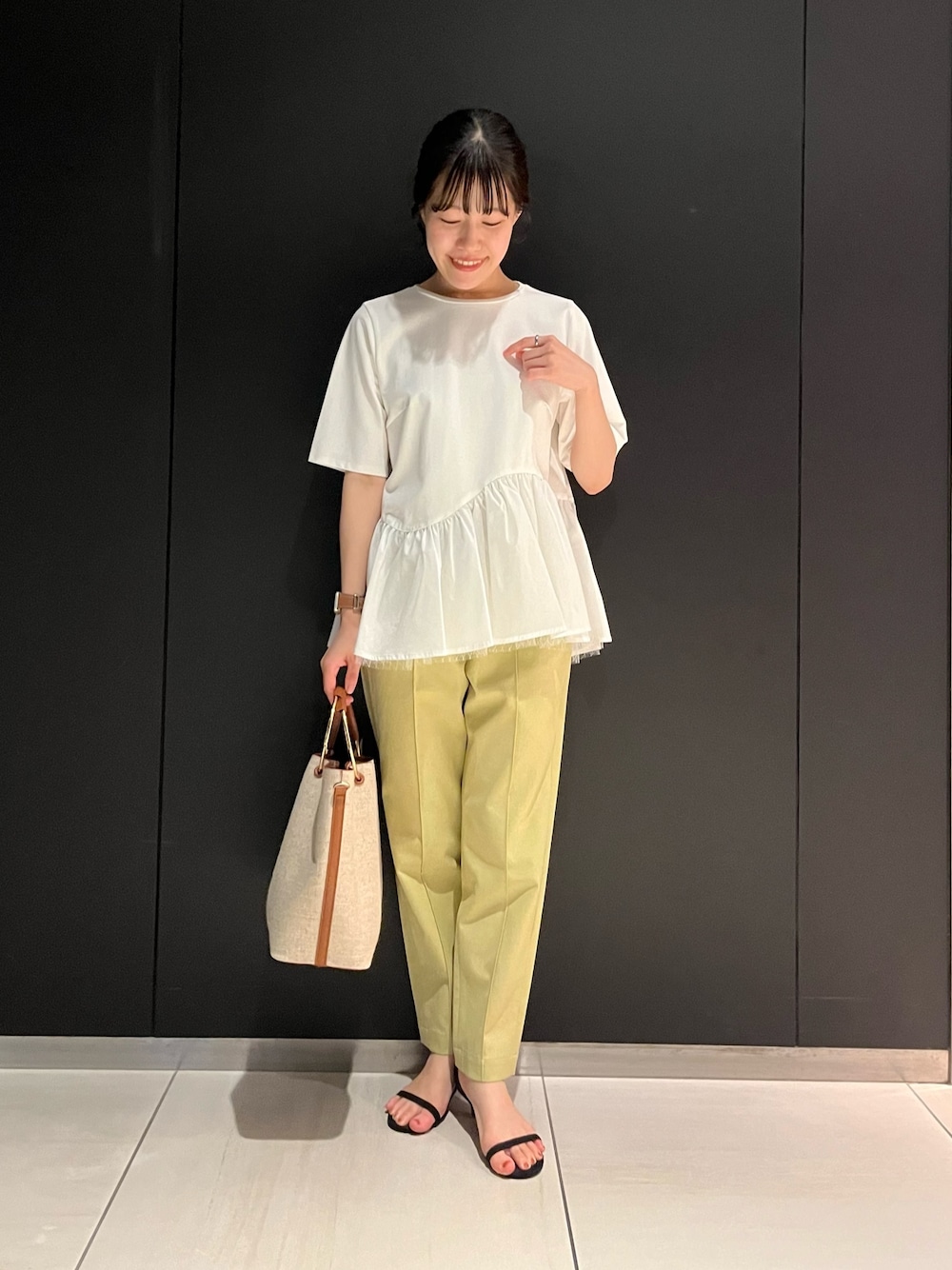 ホワイト系のTシャツ/カットソー、ブラウン系のハンドバッグ、イエロー系のその他パンツを着用したレディースの夏コーディネートの1枚目の写真