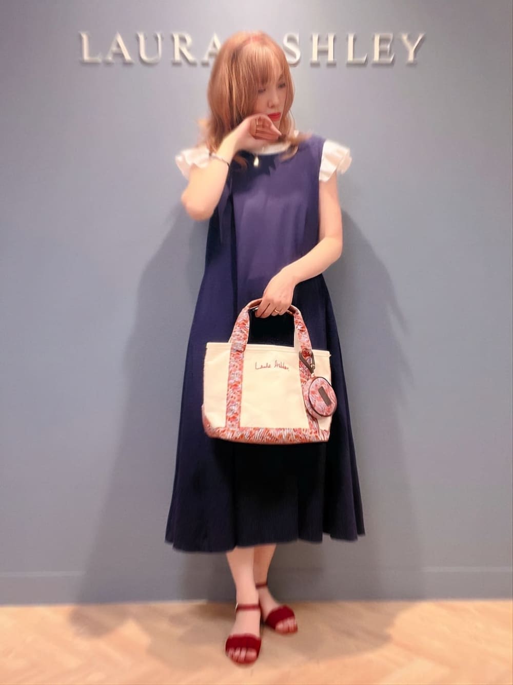 ベージュ系のトートバッグ、レッド系のシャツ/ブラウス、ピンク系のマスクを着用したレディースの夏コーディネートの1枚目の写真