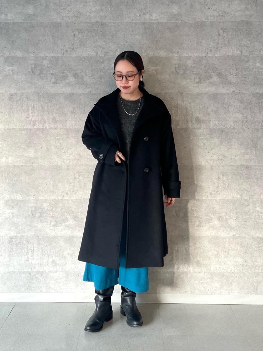 ブラック系のその他アウター、グレー系のニット/セーター、ブルー系のスカートを着用したレディースの冬コーディネートの1枚目の写真