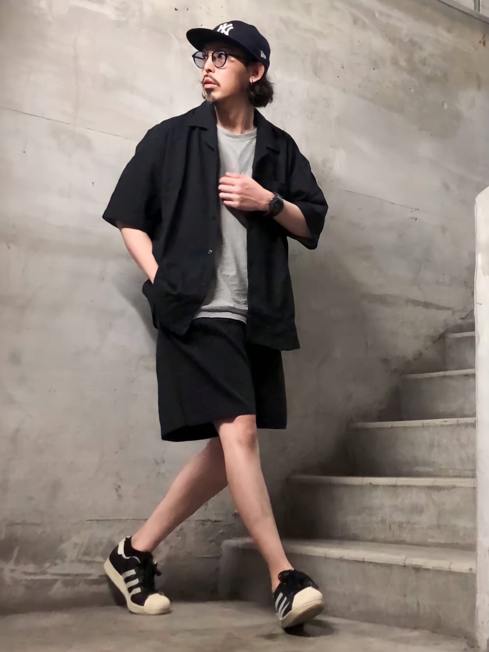 ブラック系のセットアップ、ブラック系のスニーカー、その他のサングラスを着用したメンズの夏コーディネートの1枚目の写真