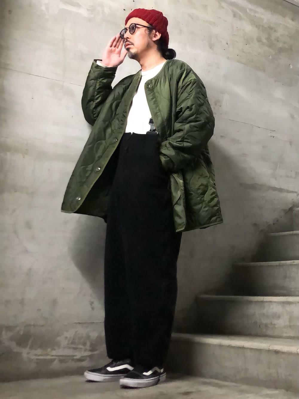 グリーン系のミリタリージャケット、ホワイト系のTシャツ/カットソー、ブラック系のスニーカーを着用したメンズの秋コーディネートの1枚目の写真