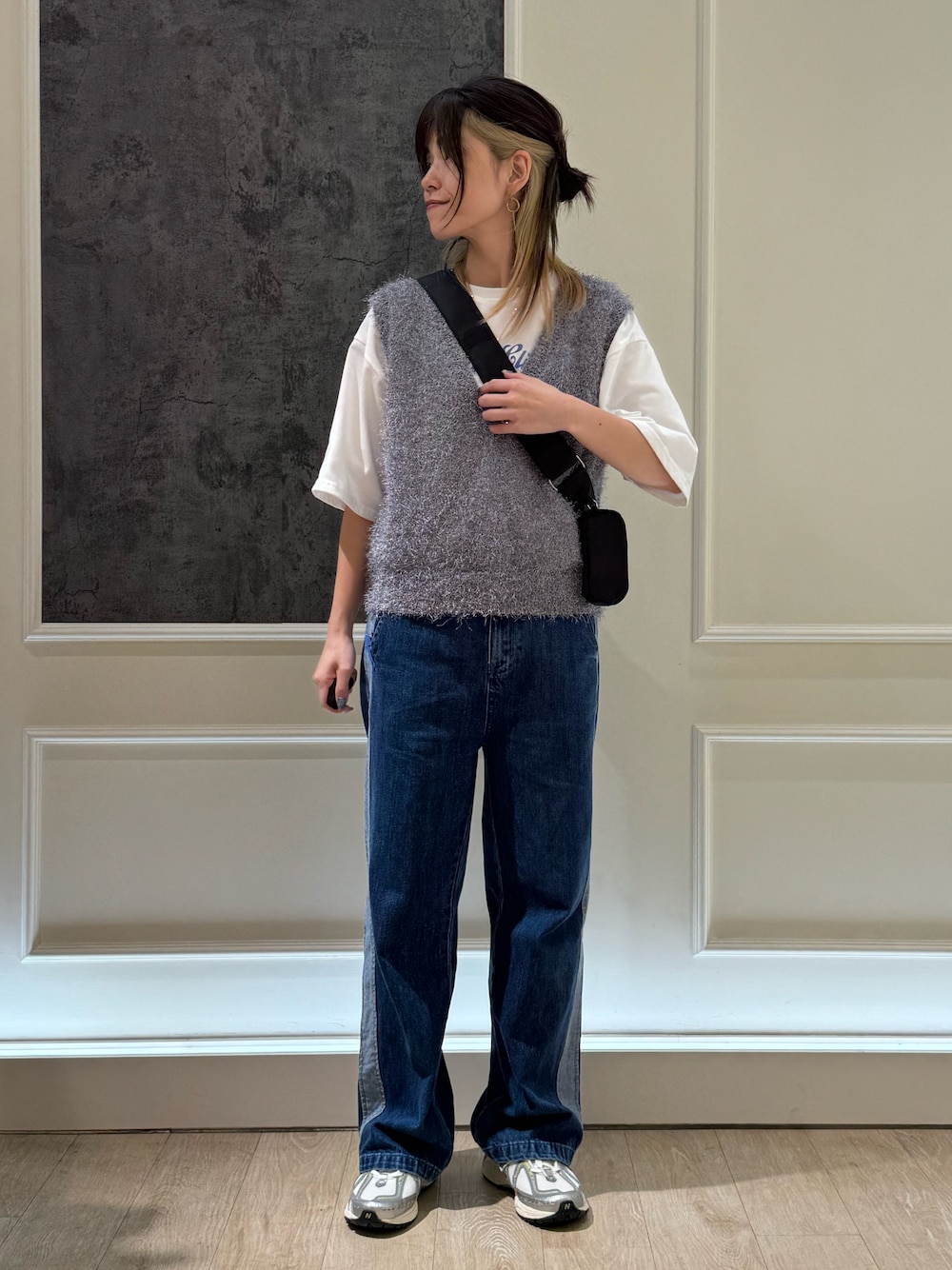 ブルー系のデニムパンツ、グレー系のベスト、ブラック系のショルダーバッグを着用したレディースの夏コーディネートの1枚目の写真