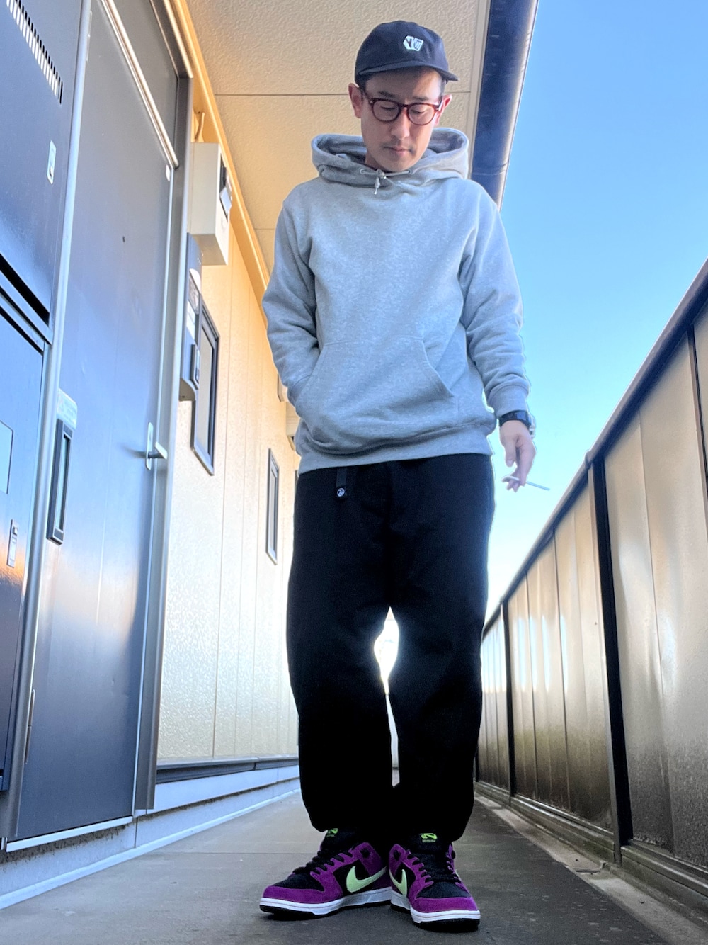 ブラック系のチノパンツ、グレー系のパーカー、ブラック系のTシャツ/カットソーを着用したメンズの秋コーディネートの1枚目の写真