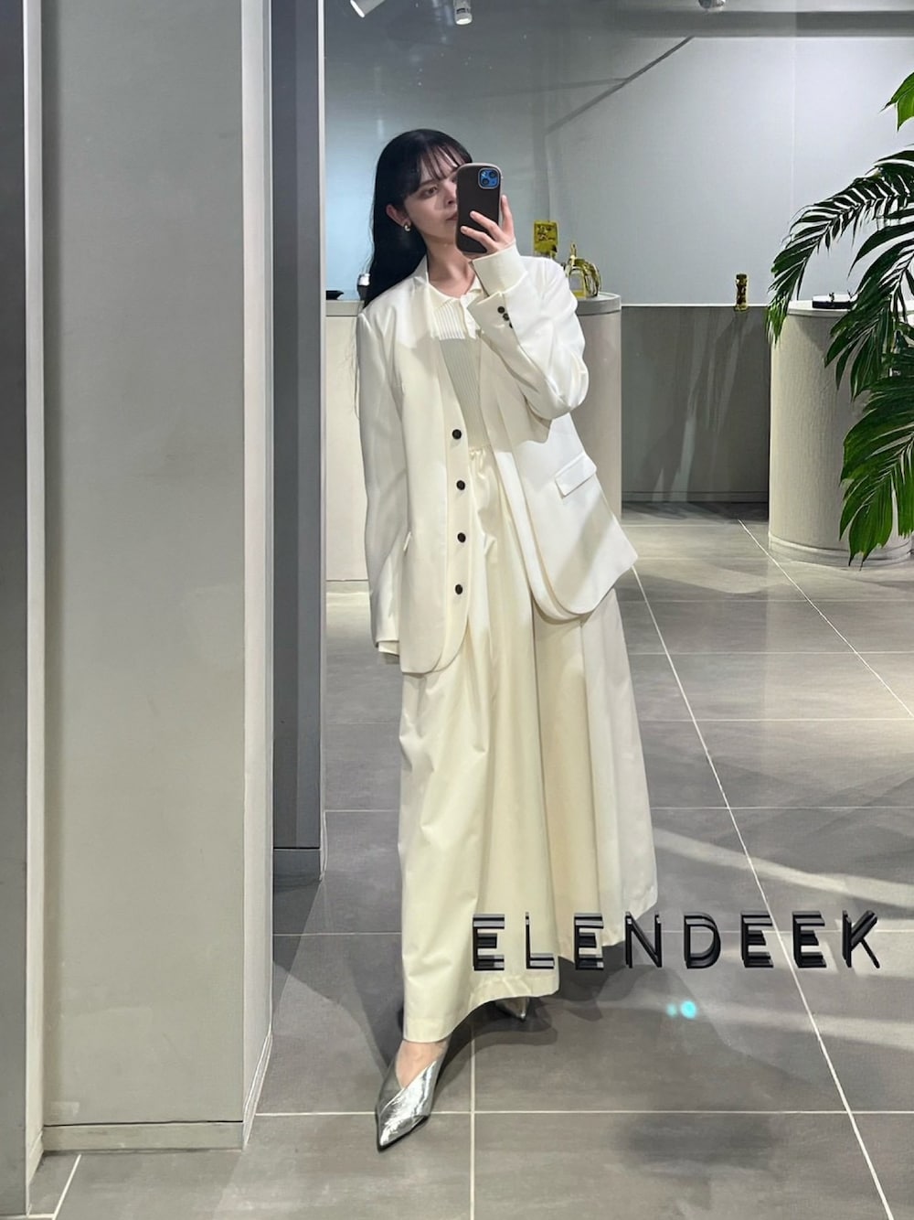 ホワイト系のノーカラージャケット、シルバー系のパンプス、ホワイト系のワンピースを着用したレディースの春コーディネートの1枚目の写真