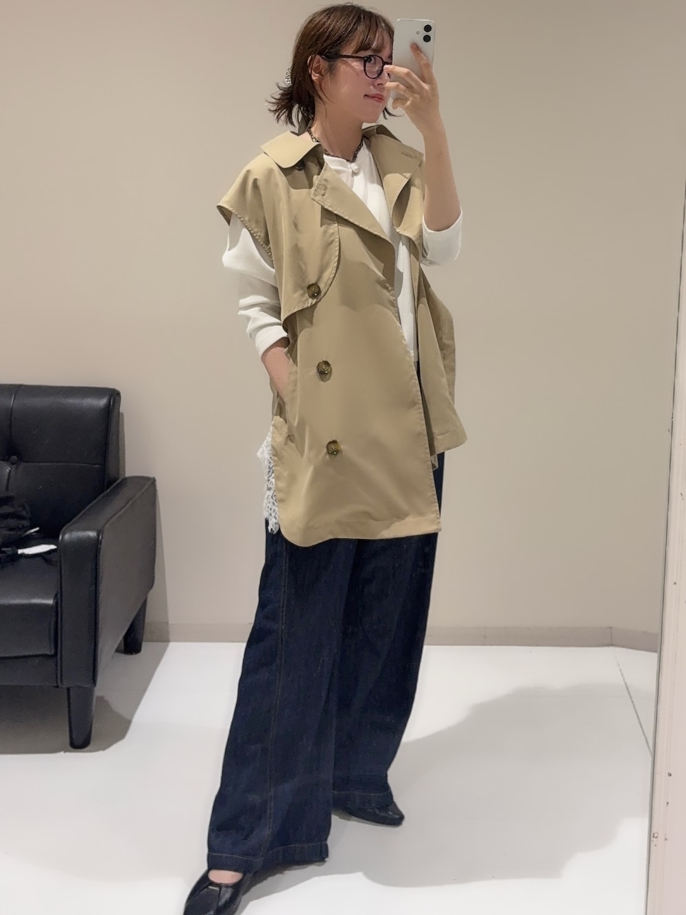 ブルー系のデニムパンツ、ホワイト系のTシャツ/カットソー、ベージュ系のベストを着用したレディースの秋コーディネートの1枚目の写真