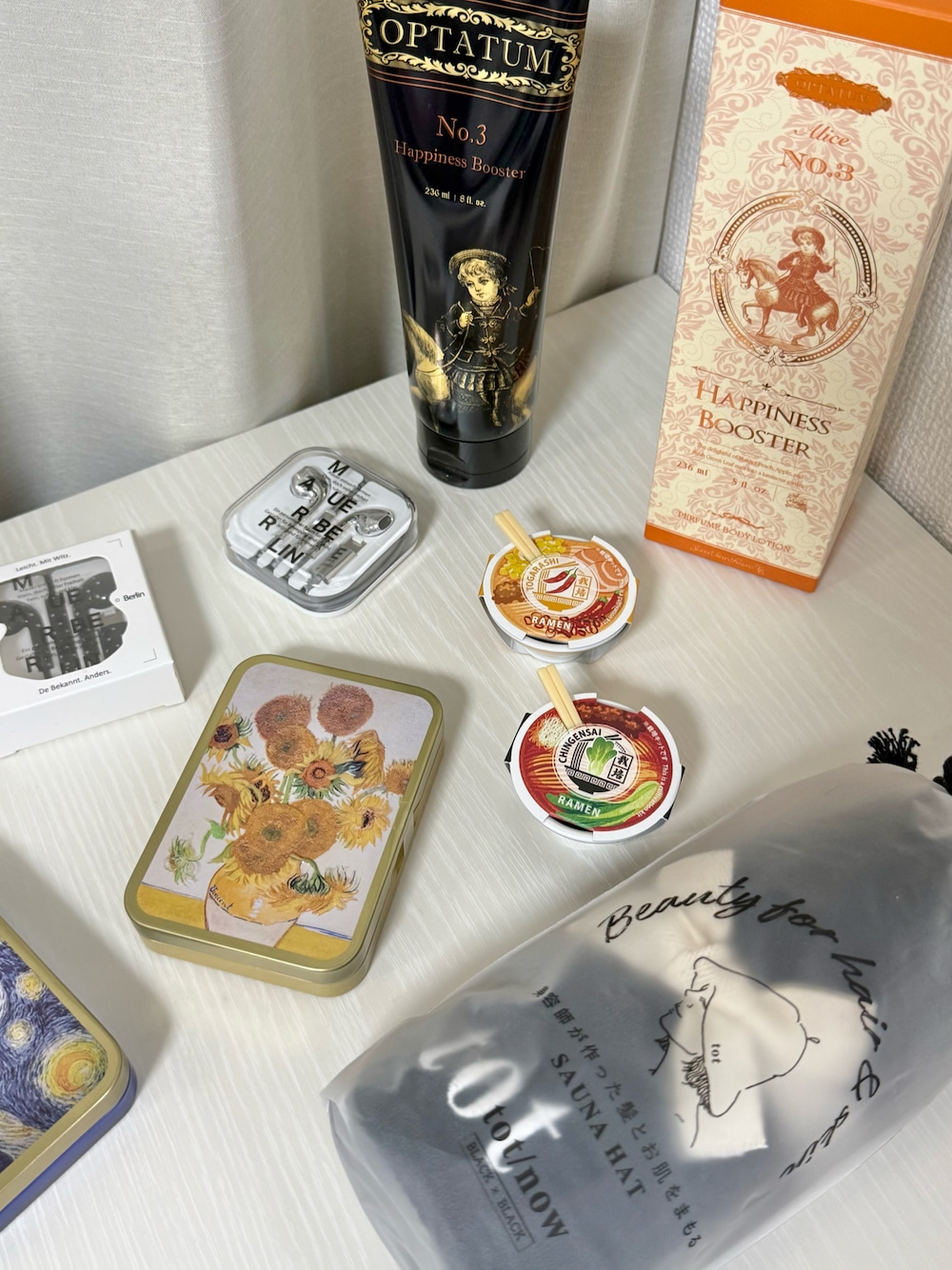 オレンジ系のボディケア/ボディクリーム、シルバー系のヘッドフォン/イヤホン、ブラック系のインテリア雑貨を着用したレディースの秋コーディネートの1枚目の写真