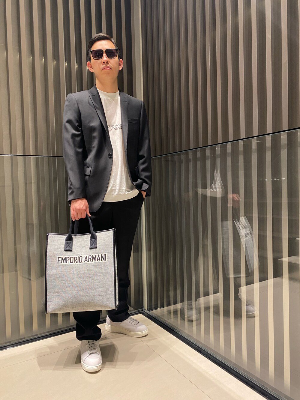 「大人コーデ、エンポリオアルマーニ、EMPORIO ARMANI、スーツスタイル、ジャケット、Tシャツ、スニーカー、キレイめ、ロゴT、黒、セットアップ、白スニーカー、トートバッグ」｜「EMPORIO ARMANIの【エンポリオ アルマーニ】シングルブレストジャケット  バージンウール製（テーラードジャケット、ブラック系）」を使った、HIRUさん（メンズ・173cm）の春コーディネートの1枚目の写真