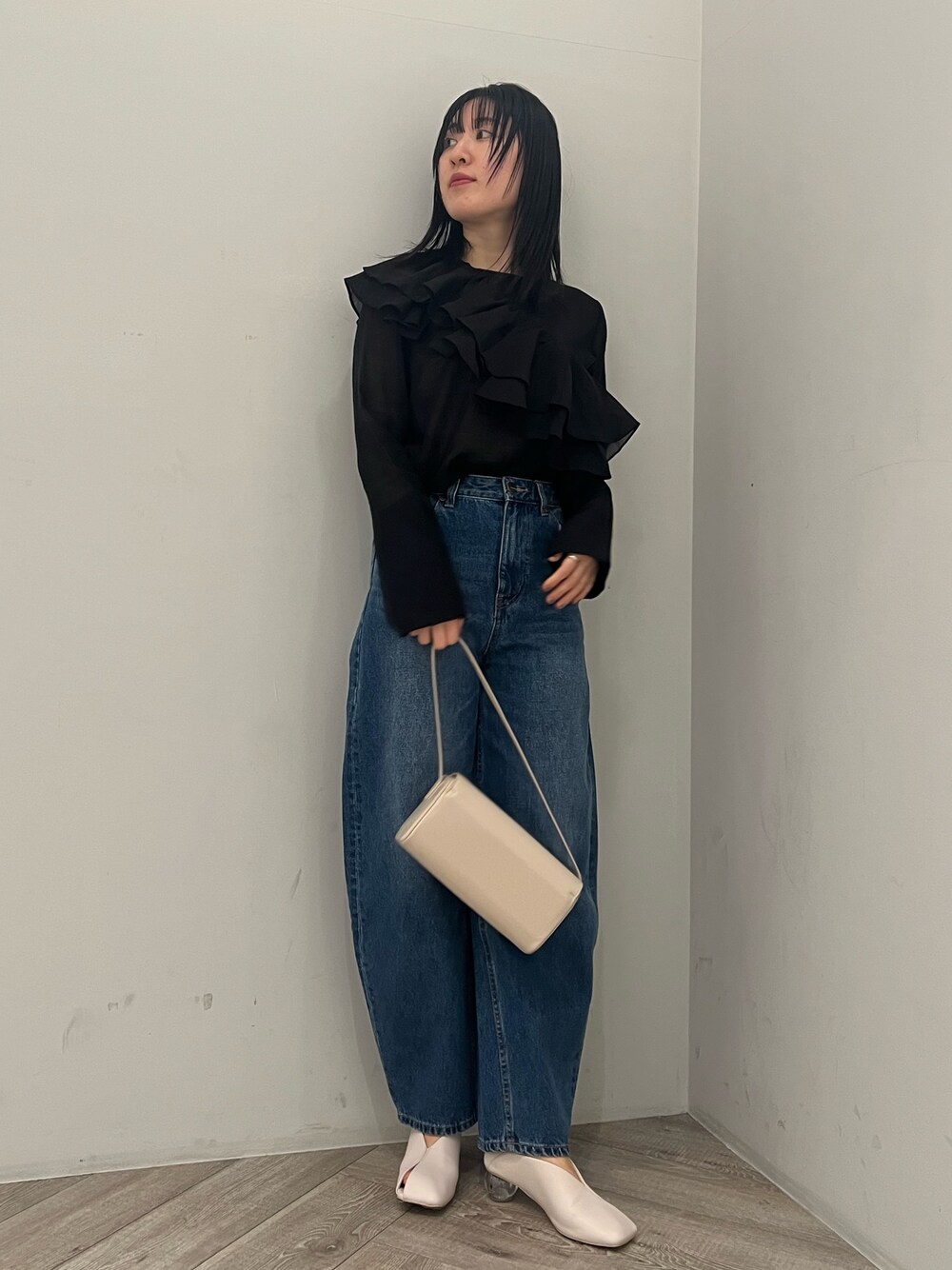 ブルー系のデニムパンツ、ブラック系のシャツ/ブラウスを着用したレディースの冬コーディネートの1枚目の写真