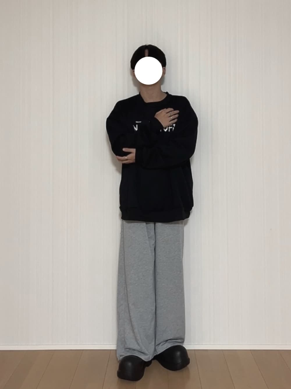 ブラック系のスウェット、グレー系のスウェットパンツ、ブラック系のスリッポンを着用したメンズの秋コーディネートの1枚目の写真