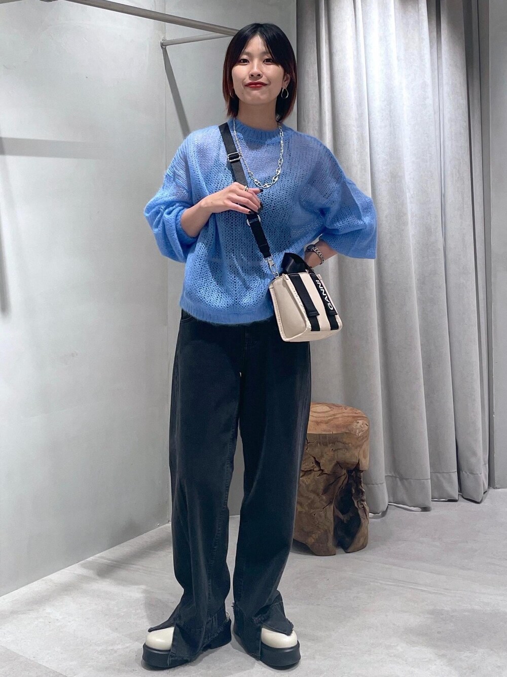 ベージュ系のトートバッグ、ベージュ系のサンダル、ブルー系のニット/セーターを着用したレディースの夏コーディネートの1枚目の写真