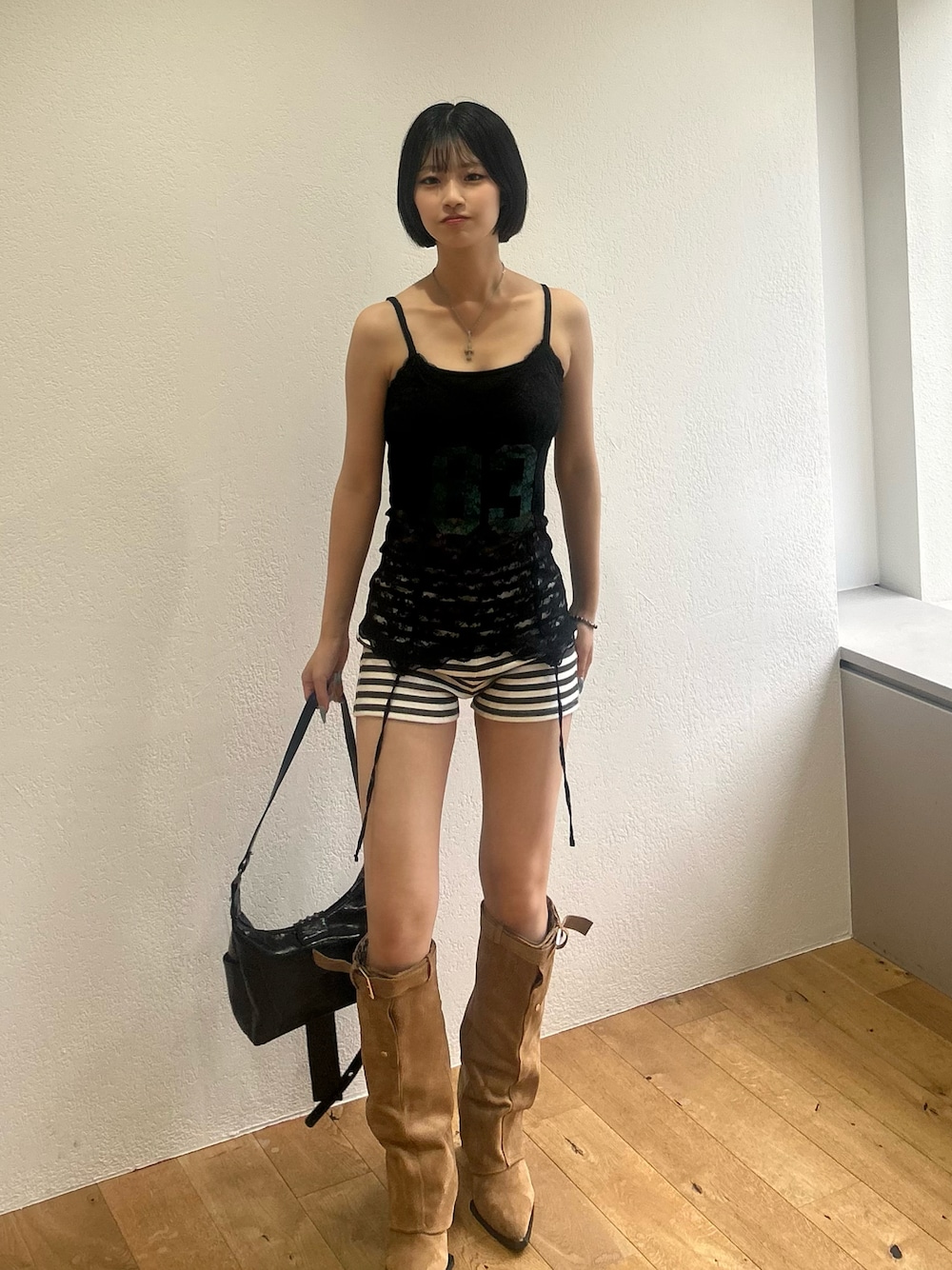 ブラック系のキャミソール、ホワイト系のその他パンツ、ブラック系のショルダーバッグを着用したレディースの夏コーディネートの1枚目の写真