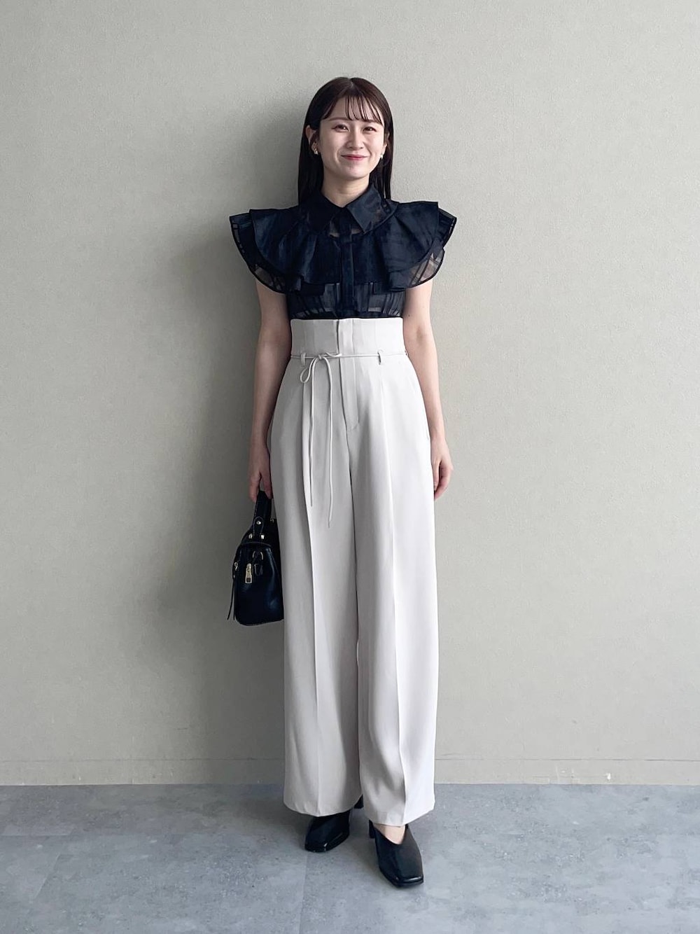 ブラック系のショルダーバッグ、ブラック系のシャツ/ブラウス、ホワイト系のその他パンツを着用したレディースの夏コーディネートの1枚目の写真