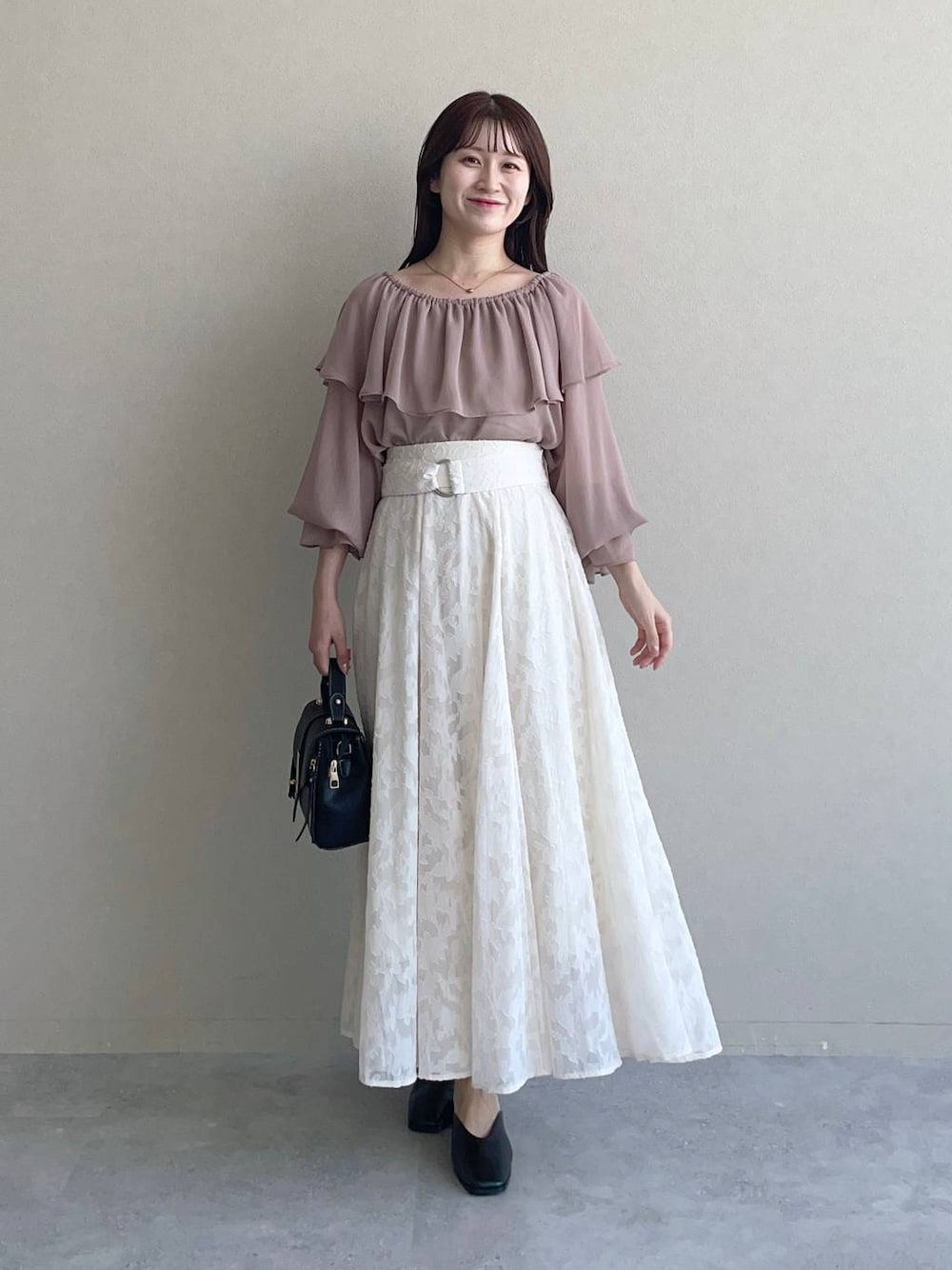 ブラック系のショルダーバッグ、ホワイト系のスカート、ブラウン系のシャツ/ブラウスを着用したレディースの夏コーディネートの1枚目の写真