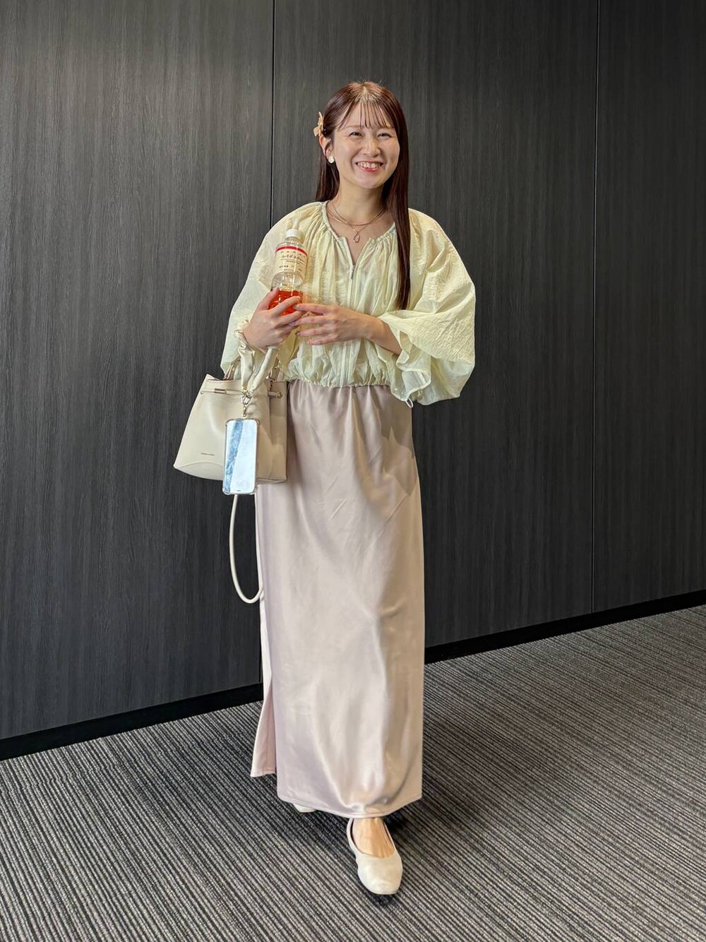 ベージュ系のパンプス、ホワイト系のシャツ/ブラウス、ベージュ系のスカートを着用したレディースの夏コーディネートの1枚目の写真