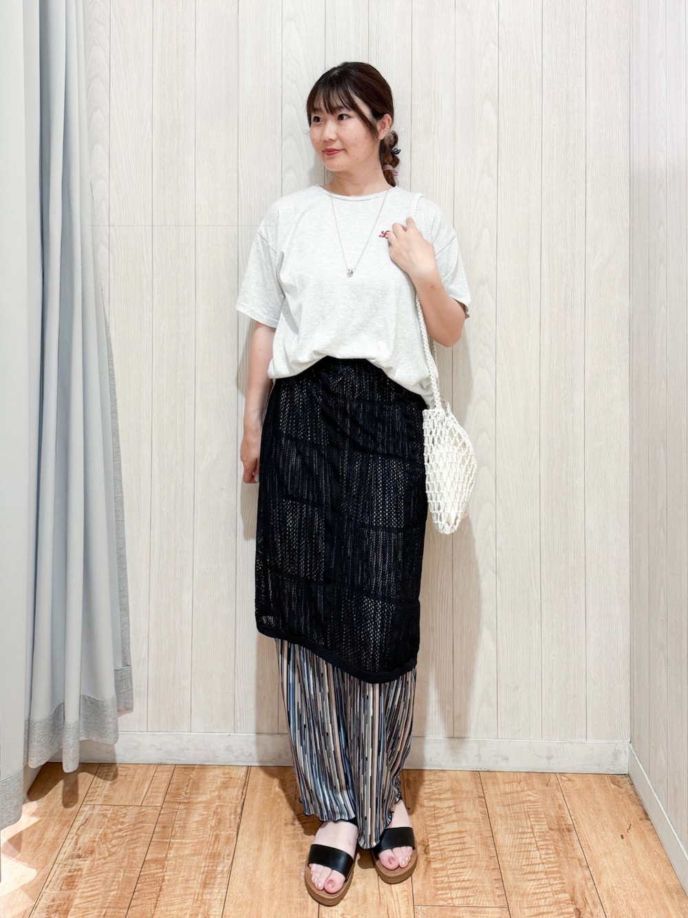 ホワイト系のTシャツ/カットソー、ブラック系のスカート、ホワイト系のショルダーバッグを着用したレディースの夏コーディネートの1枚目の写真
