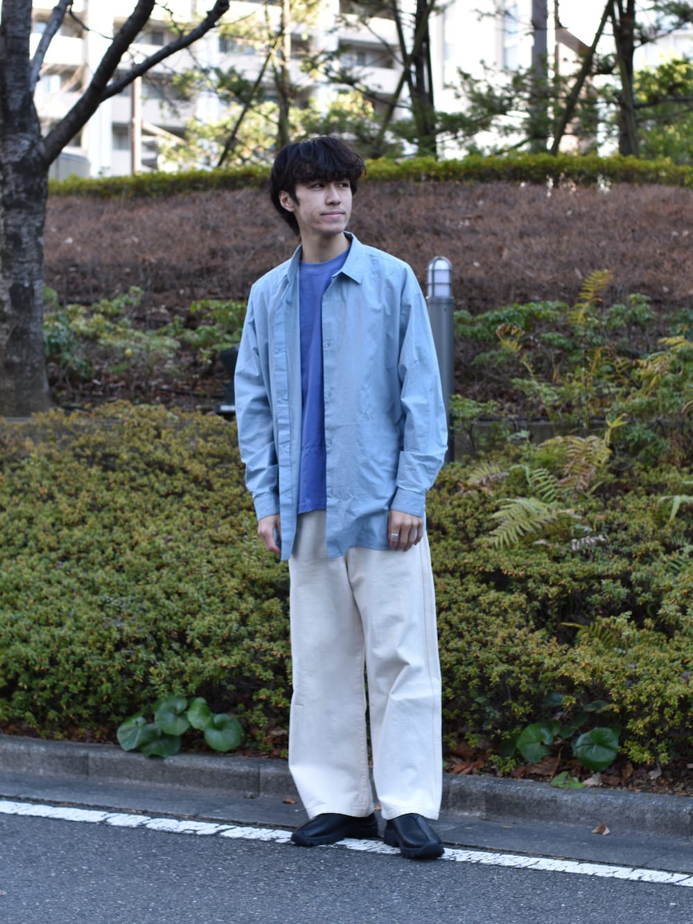 ブルー系のシャツ/ブラウス、ブラック系のスリッポン、ブルー系のTシャツ/カットソーを着用したメンズの冬コーディネートの1枚目の写真