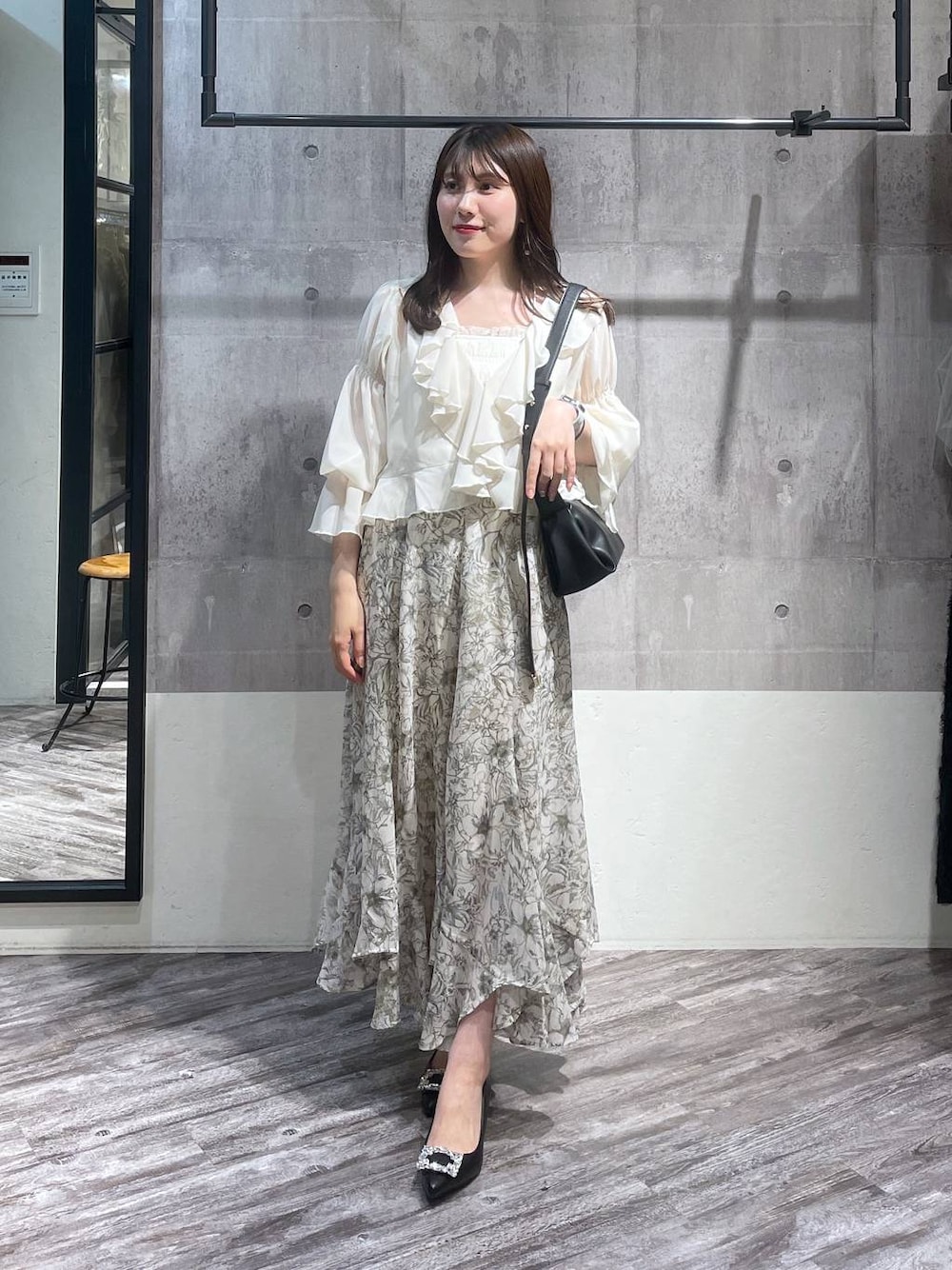 ホワイト系のシャツ/ブラウス、ブラック系のパンプス、ホワイト系のスカートを着用したレディースの春コーディネートの1枚目の写真