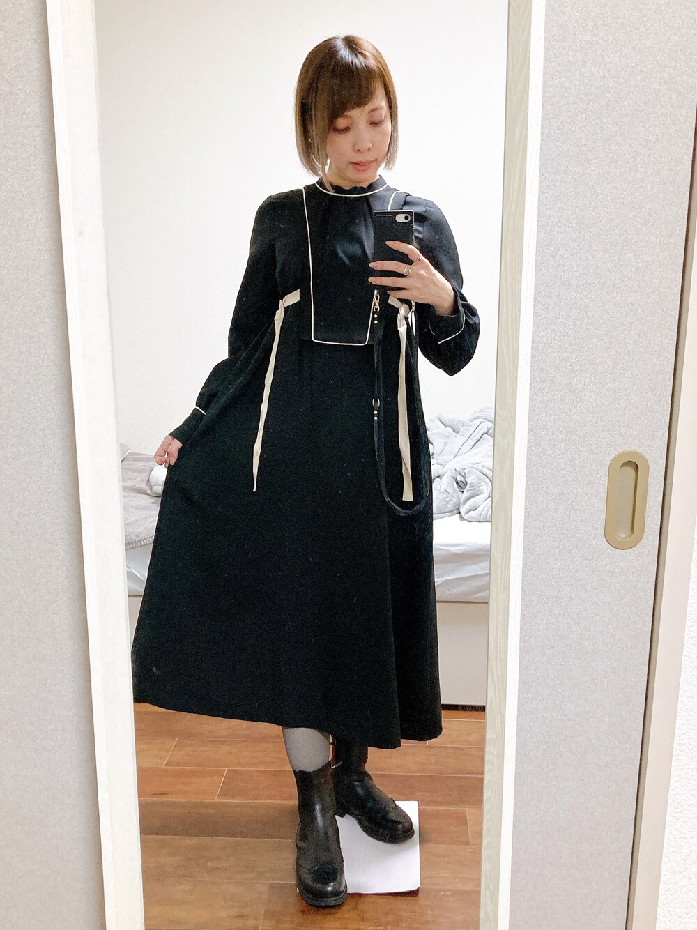 「仕事着、ブーツスタイル、黒ワンピ、ブルベ夏、骨格ウェーブ、顔タイプフレッシュ」｜「UNITED TOKYOのパイピングフレアワンピース（ワンピース、ブラック系）」を使った、hikaruさん（レディース・157cm）の冬コーディネートの1枚目の写真